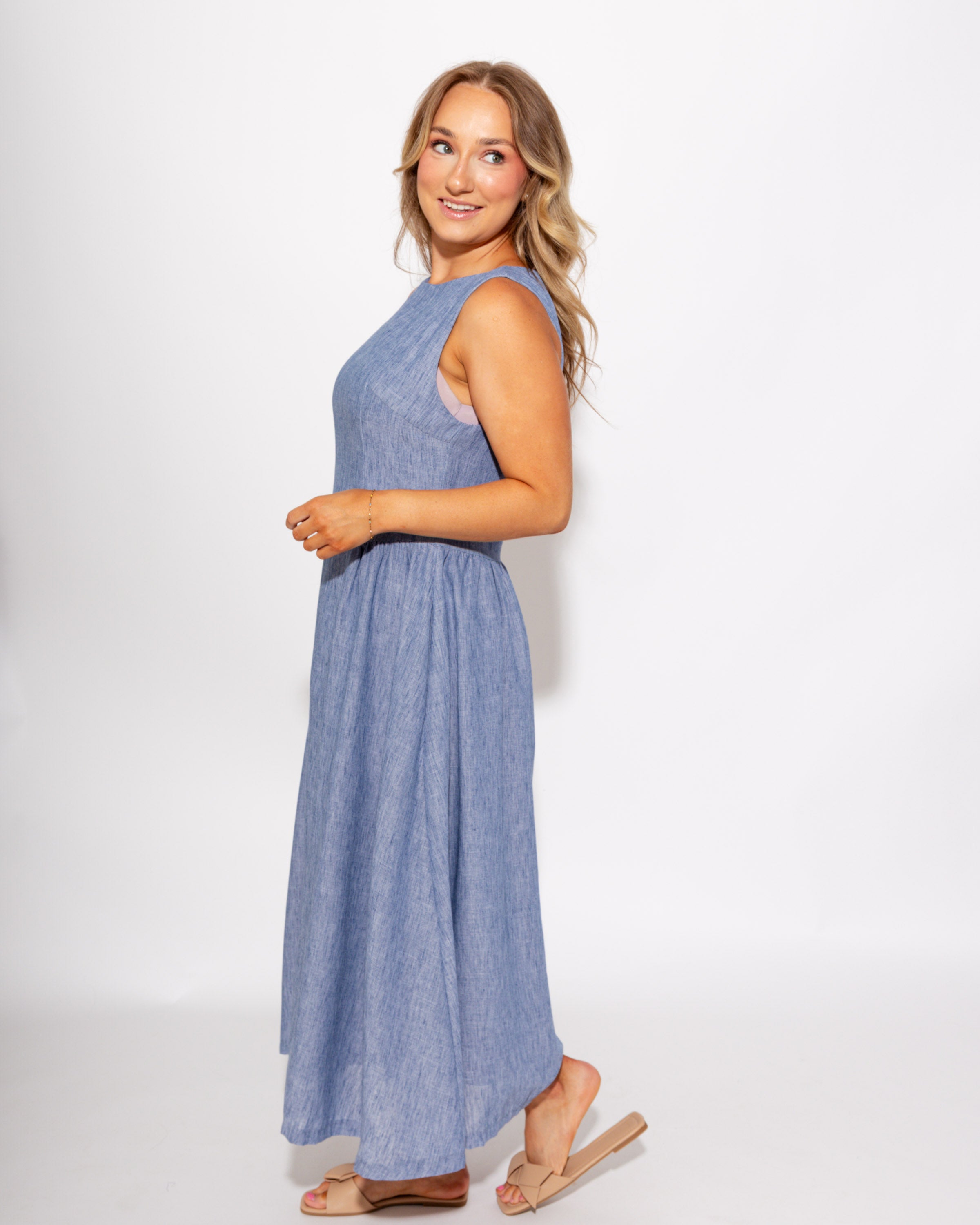 Light blue sleeveless pleated A-line midi dress detail view, boutique dress at Gaudie & Co